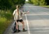 Hitchhiker catching car on highway