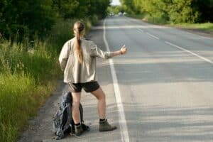 Hitchhiker catching car on highway