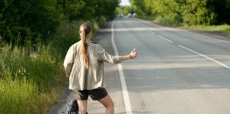 Hitchhiker catching car on highway