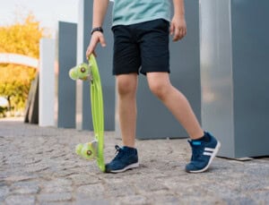 close-up-legs-blue-sneakers-with-green-skateboard-active-urban-lifestyle-youth-training-hobby-activity-active-outdoor-sport-kids-child-skateboarding- close-up-legs-blue-sneakers-with-green-skateboard-active-urban-lifestyle-youth-training-hobby-activity-active-outdoor-sport-kids-child-skateboarding-